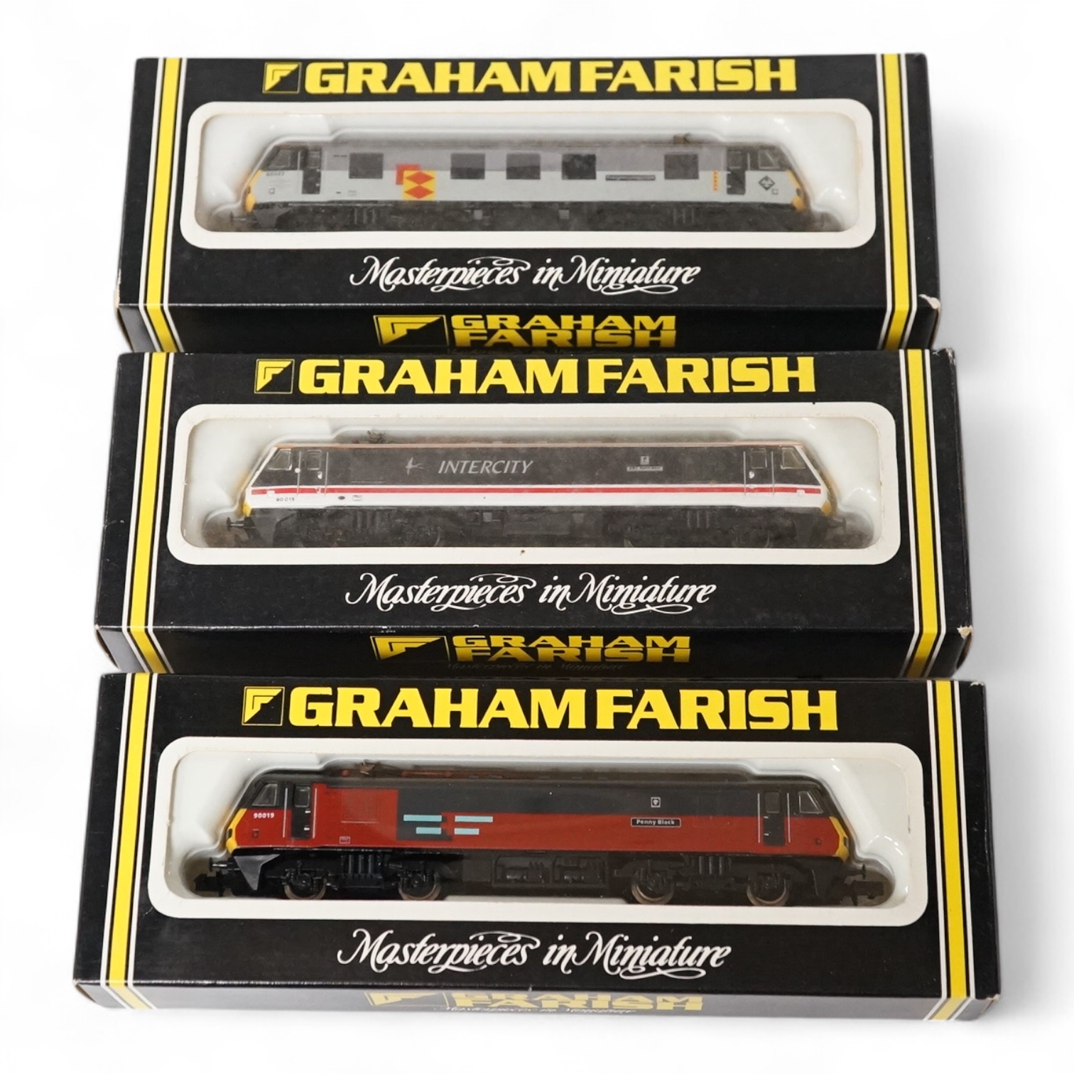 Three boxed Graham Farish N gauge railway Class 90 electric locomotives; BR 90022 Freight connection (8828), Intercity 90015 BBC North West (8827) and Rail Express 90019 Penny Black (8825). Condition - good.
